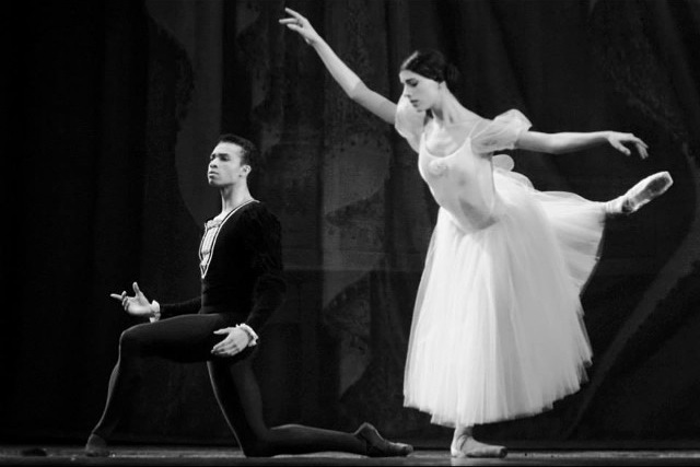 Sara Ezzell performing in Giselle with a kneeling male dancer