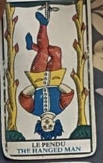 XII · The Hanged Man cropped from the complete photographed October spread
